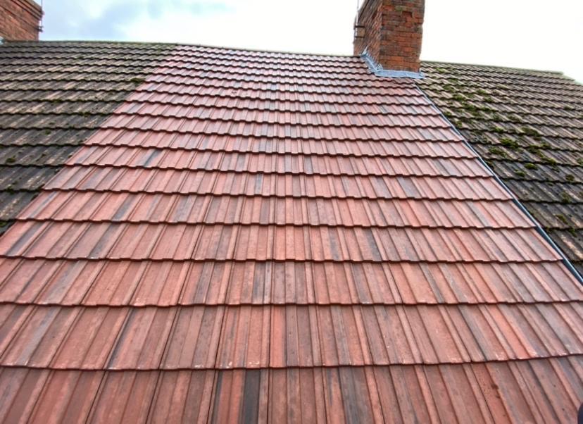 Finished terracotta tile roof between older roofs