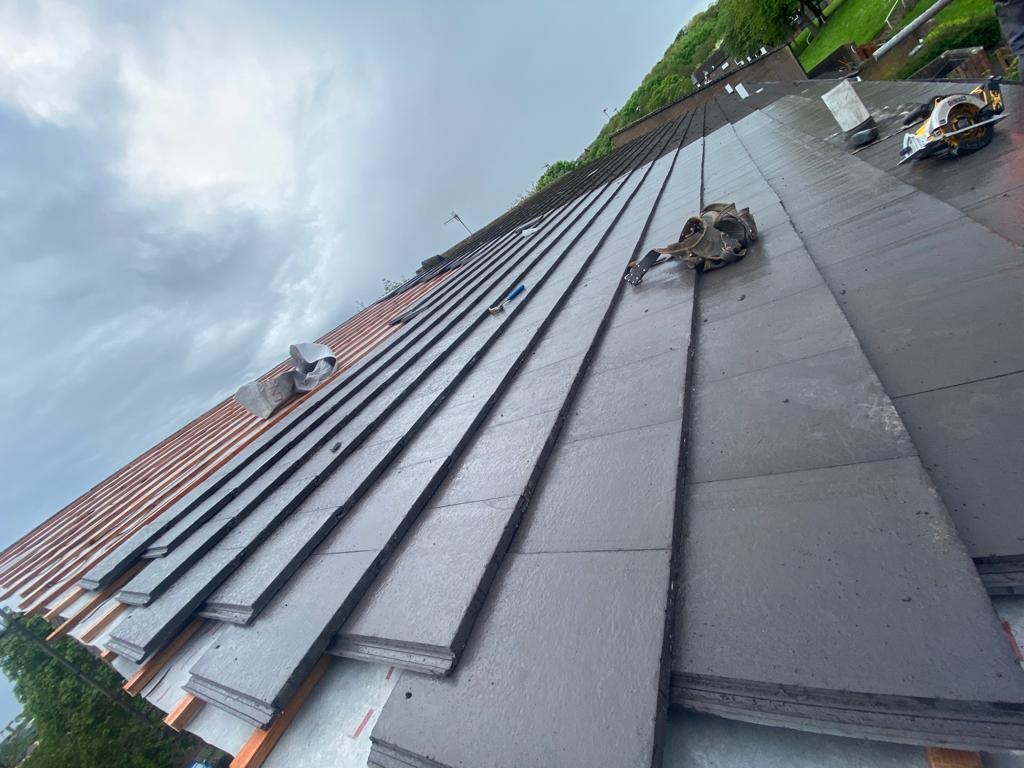 Slate roofing in progress on a terrace house